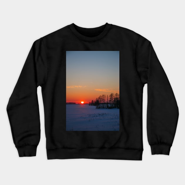 Sunset winter landscape with snow-covered road in violet and pink colors Crewneck Sweatshirt by Olga Berlet